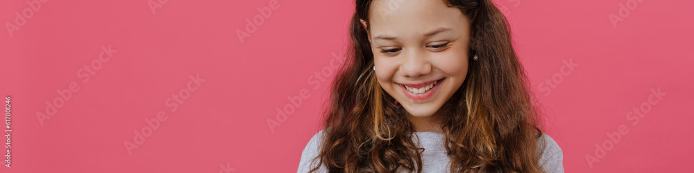 White preteen girl playing online game on mobile phone White preteen girl playing online game on mobile phone