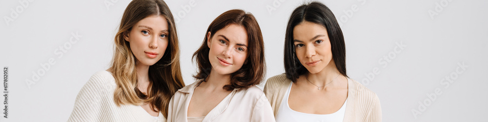 Three gorgeous brunette women posing at camera together Three gorgeous brunette women posing at camera together