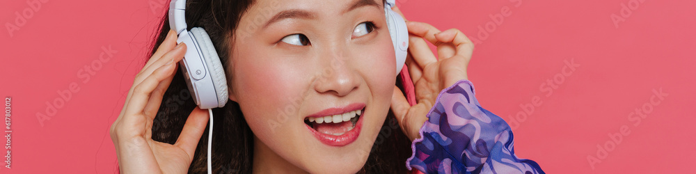 Portrait of young beautiful smiling happy asian girl in headphones Portrait of young beautiful smiling happy asian girl in headphones