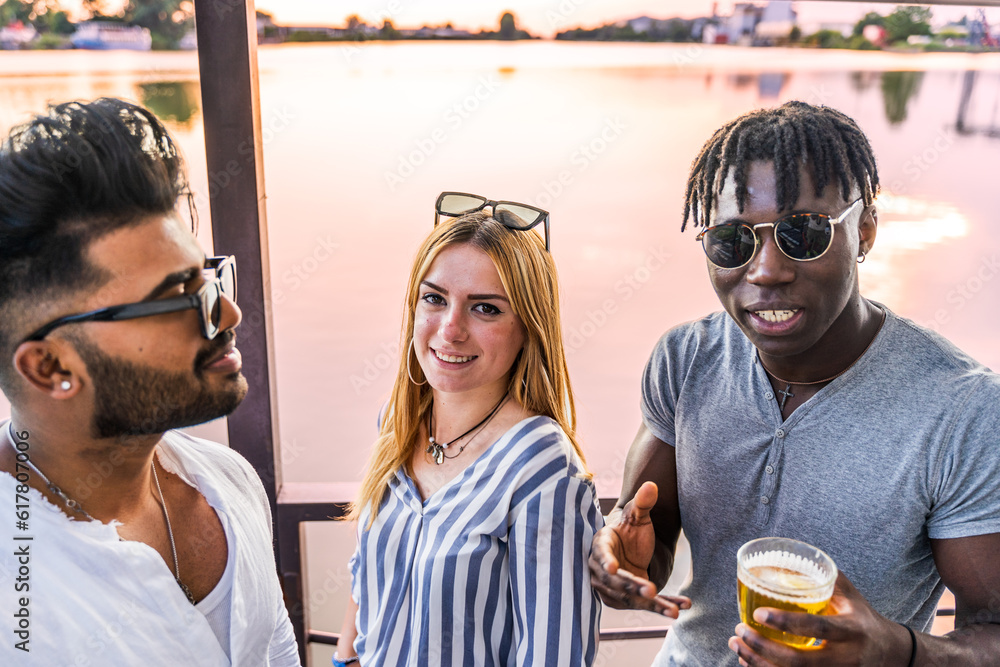 small group of young adult multiethnic friends celebrating toasting with alcohol small group of young adult multiethnic friends celebrating toasting with alcohol
