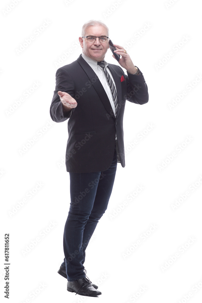 in full growth. businessman talking on a smartphone in full growth. businessman talking on a smartphone