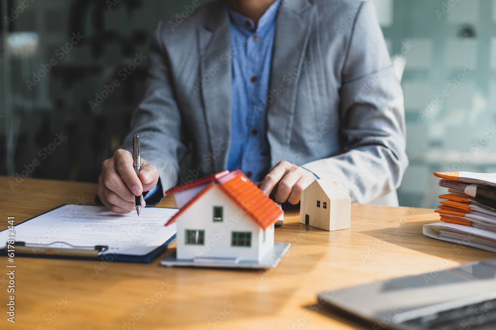 Businessmen, real estate agents signing agreements for buying and selling houses, mortgages, rentals, loans.