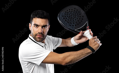 Padel tennis player. Man athlete with paddle tenis racket on black background. Sport concept. Download a high quality photo for sports website. © Mike Orlov