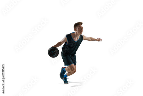 Dynamic image of young man, athlete running with ball, playing basketball isolated against white background. Concept of sport, action and motion, health, game, hobby, sportswear, ad