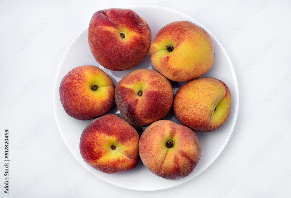 Juicy peaches on a white plate. Yellow-red large ripe peaches. Juicy fruits. Juicy peaches on a white plate. Yellow-red large ripe peaches. Juicy fruits.
