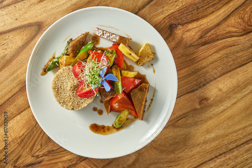 Asparagus with seitan, tofu cheese in a white plate. Vegetarian food