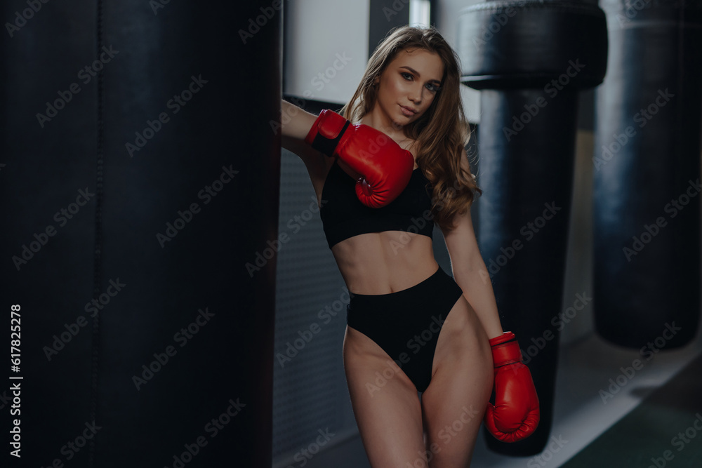 Sexy woman boxer posing at the box club