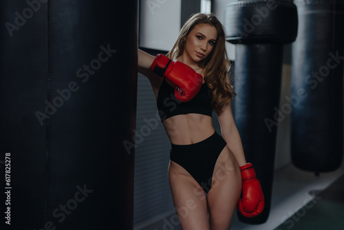 Sexy woman boxer posing at the box club
