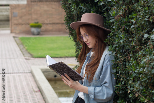 young beautiful student latina reading a book in a park in bogota 