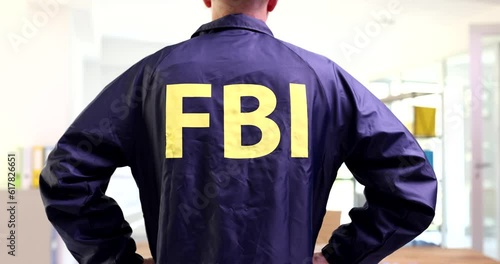 Federal bureau of investigation service officer in FBI uniform rear view 4k movie. Prestigious job in police concept photo