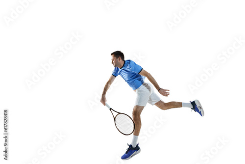 Active man in blue shirt and white shorts, tennis player in motion, training, playing isolated over white background. Concept of sport, active lifestyle, game, hobby, health, dynamics, ad