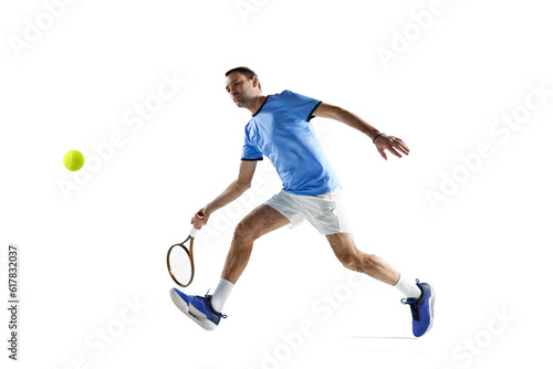 Active, sportive man in uniform playing tennis, hitting ball with racket during game isolated over white background. Concept of sport, active lifestyle, game, hobby, health, dynamics, ad © master1305