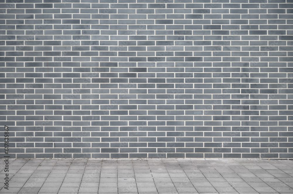 Panoramic background of wide old grey brick wall texture and flooring. Home or office design backdrop.