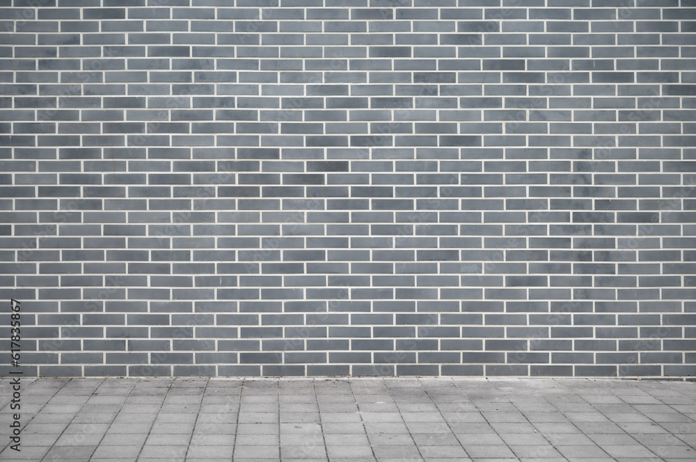 Fototapeta premium Panoramic background of wide old grey brick wall texture and flooring. Home or office design backdrop.