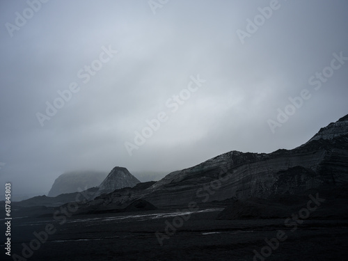 Mýrdalsjökull Glacier covered in sand and dark soil. By the entrance of Katla Ice Cave. South Iceland.