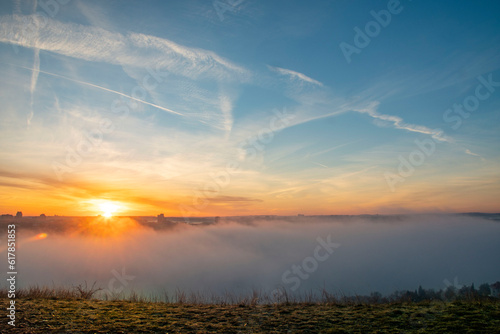 foggy sunrise with blue sky and sunshine in Prague