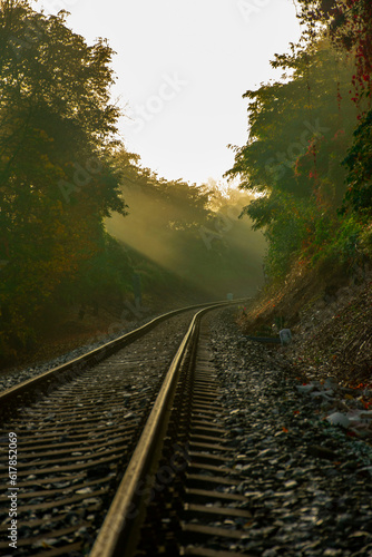 railway on autumn with sunrays and haze
