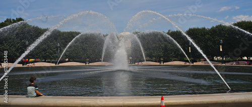 Child sit on Water fontain on the national gallery museum garden on national mall in Washington DC, USA photo