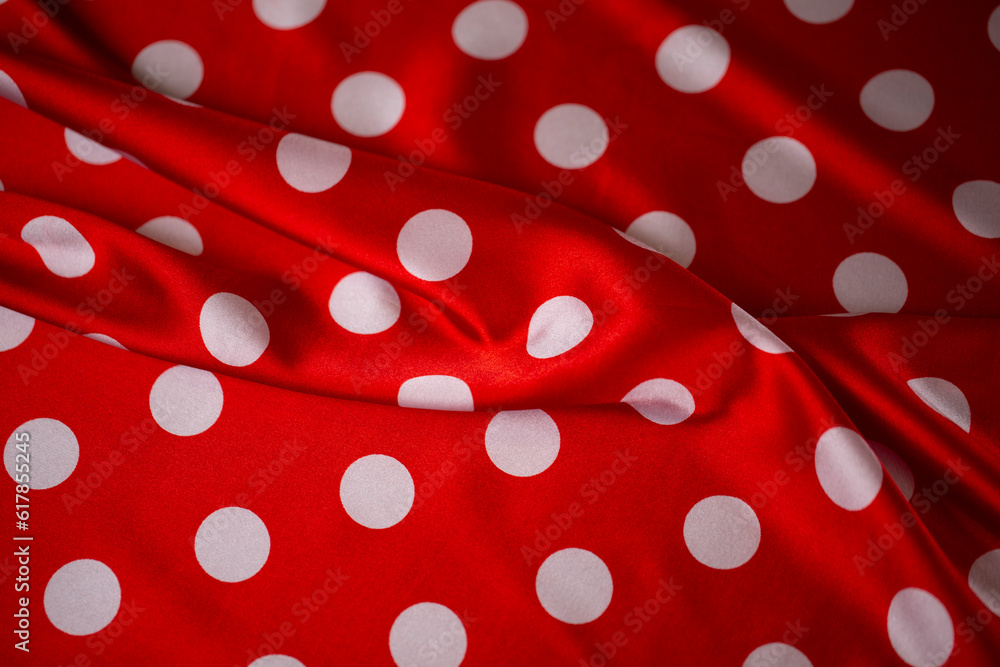 Red silk fabric with large white polka dots. Polka dot background. Red silk fabric with large white polka dots. Polka dot background.