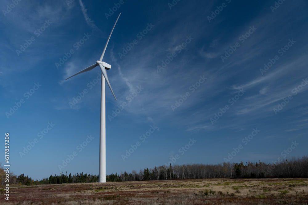 White windmill in the fields, with blue sky. Eolian Energy. White windmill in the fields, with blue sky. Eolian Energy.