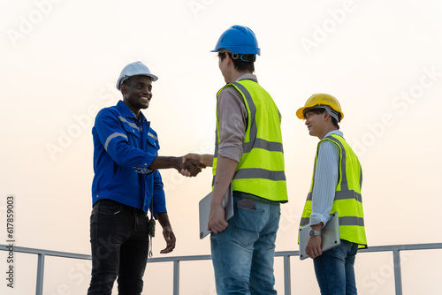 African american technician handshake for teamwork,successful negotiate,hand shake,two Engineer shake hand with partner to celebration partnership and business deal concept