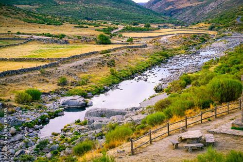 Panoramic of the Barbellido river with its round stones from the El Mellizo refuge area in the Sierra de Gredos