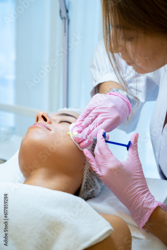 Cosmetology for young female, beautician doctor making injection to face, prp ttherapy. photo