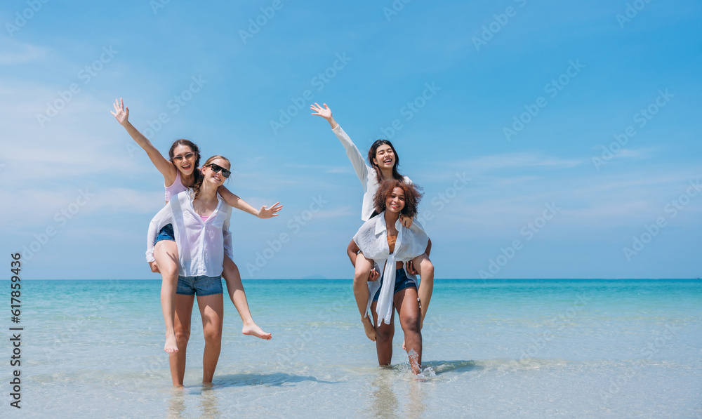 Happy children laughing and enjoying at beach. Teenage playing with friends at the sea. Vacations time and friendship concept. Happy children laughing and enjoying at beach. Teenage playing with friends at the sea. Vacations time and friendship concept.