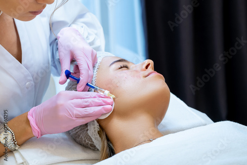 Cosmetologist doing PRP ttherapy in beauty clinic, making injection.