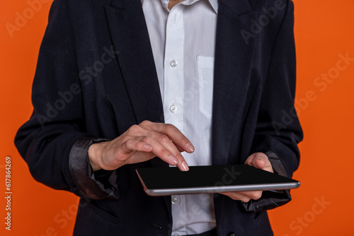 Unrecognizable woman wearing black official style suit using tablet