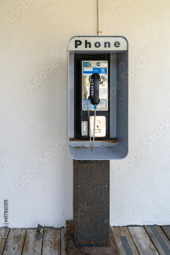 Vintage, old school payphone mounted on metal stand.