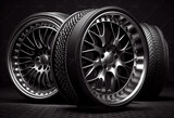 A stack of new car wheels with aluminum rims on a black background. AI generative.