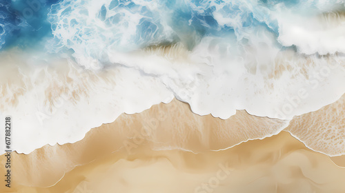Satellite view of a beach with blue water, white waves and golden sand