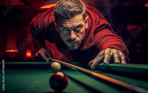 A billiard player is about to hit the ball with his cue. photo