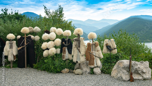 Georgian papakhas are sold to tourists against the backdrop of mountains. Journey along the military Georgian road. photo