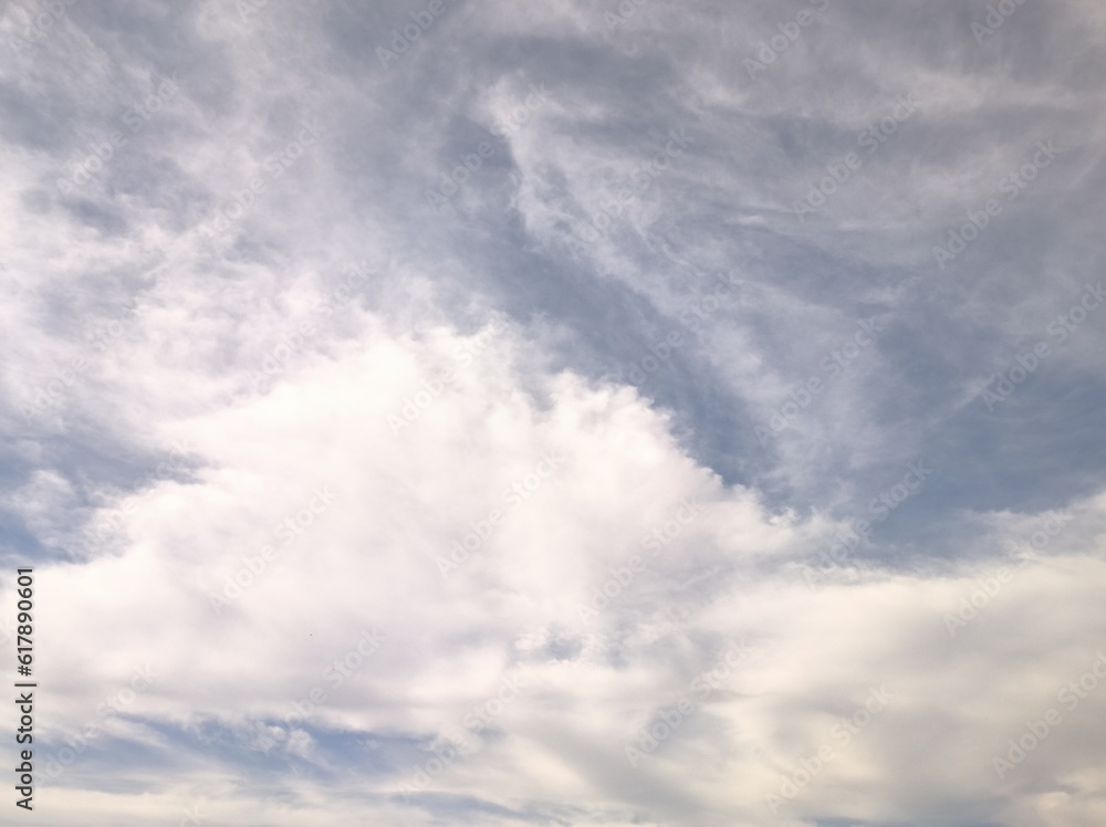 Cirrostratus with cumulus clouds in the sky
