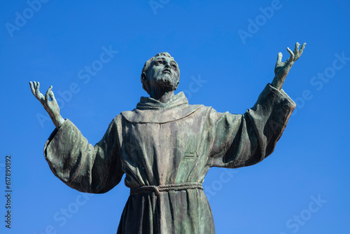 NAPLES, ITALY - APRIL 22, 2023: The bronze statue of St. Francis of Assisi near the church Basilica dell'Incoronata Madre del Buon Consiglio from 20. cent.