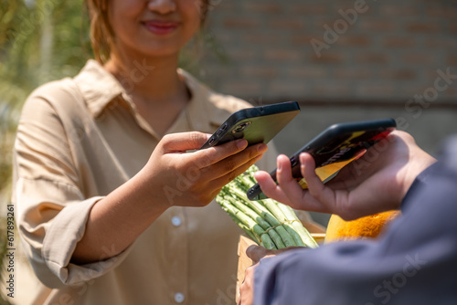 Grocery man delivers service organic vegetable and fruit, Asia customer woman scan QR code payment and pick up purchase online shopping food