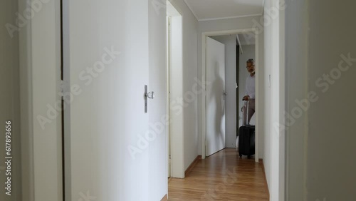 Business person leaving home. Black man goint to travel with suitcase and bag. photo