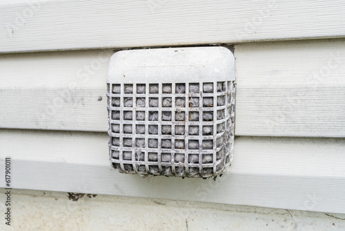dryer vent guard is plugged with lint and debris and is a fire hazard