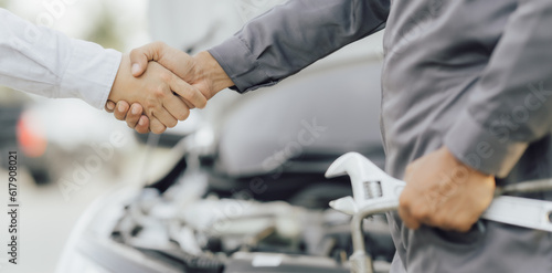 The male mechanic's hand holds the wrench Are showing solidarity with colleagues , Concept of engineer and auto repair