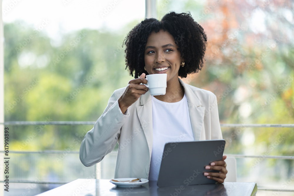 Pretty black lady businesswoman sitting at cafe, using digital tablet Pretty black lady businesswoman sitting at cafe, using digital tablet