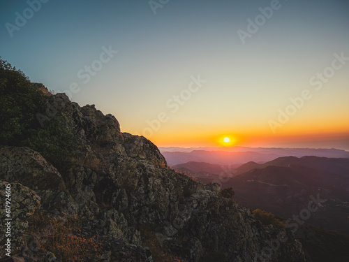 Through the mountains I see a sunset on the top of a mountain in Cyprus