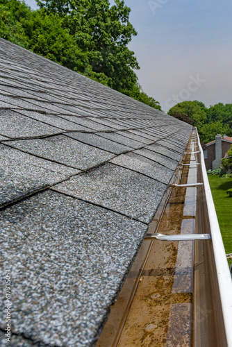Clogged gutters that had not been cleaned last fall. Rainwater fills and gutters overflow with rain water Water can damage the house siding, a wet basement, and erosion in the landscaping
