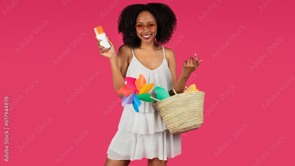 Glad young black curly lady in sunglasses with basket show jar sunblock Glad young black curly lady in sunglasses with basket show jar sunblock