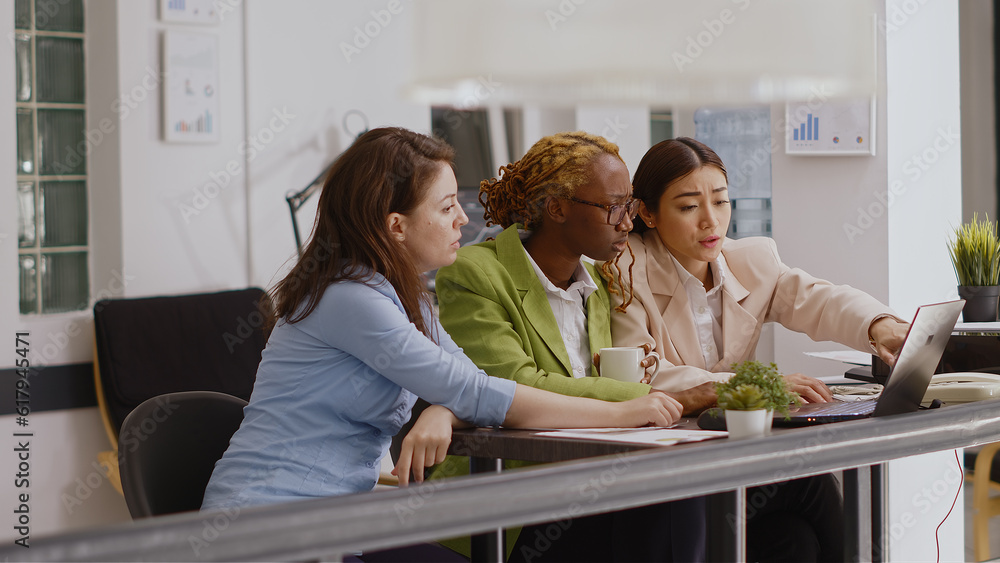 Multiethnic people presenting analytics report in office, planning business development to increase profit. Young colleagues attending corporate meeting for online investment plan. Multiethnic people presenting analytics report in office, planning business development to increase profit. Young colleagues attending corporate meeting for online investment plan.