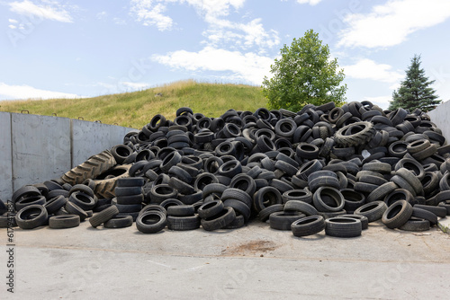 Heap of old used industrial rubber tires specially selected from the garbage in a recycling plant for separate recycling