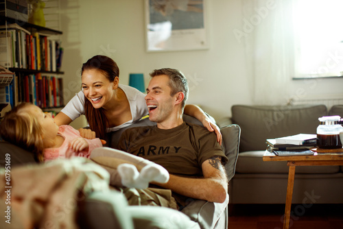 Father reuniting with his wife and daughter at home after deployment