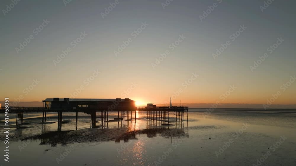 Southport, Lancashire, UK, December 8, 2022; Low aspect aerial orbital clip of the beautiful sunset and Southport pier, England, UK Southport, Lancashire, UK, December 8, 2022; Low aspect aerial orbital clip of the beautiful sunset and Southport pier, England, UK