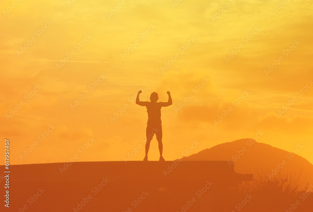 Strong Fit Man Standing Against a Vibrant Sunset Feeling Confident 
